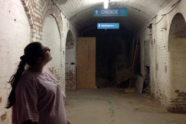 photo looking down the corridor with sign saying 'choice' - MADHOUSE re:exit