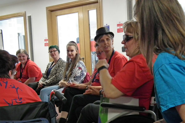 photo of people sitting in a circle talking and listening