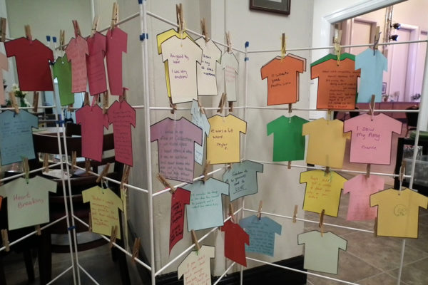 Photo of feedback written paper T-shirts and hung on a washing line